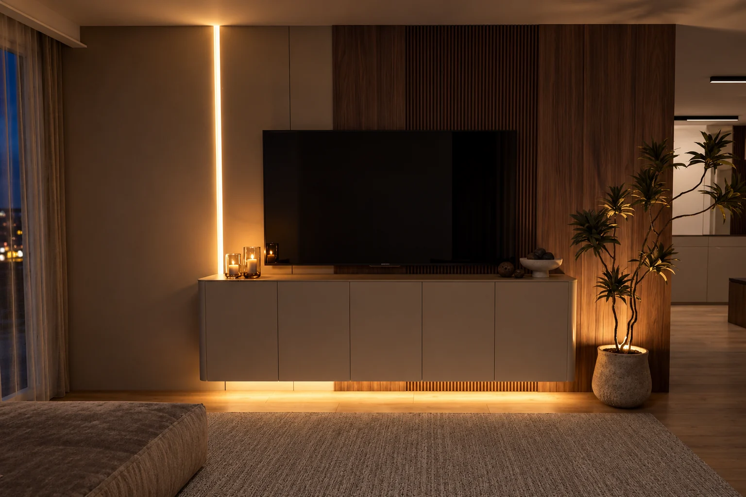 The living room TV wall in the evening, with concealed light strips under the TV unit and along the wall