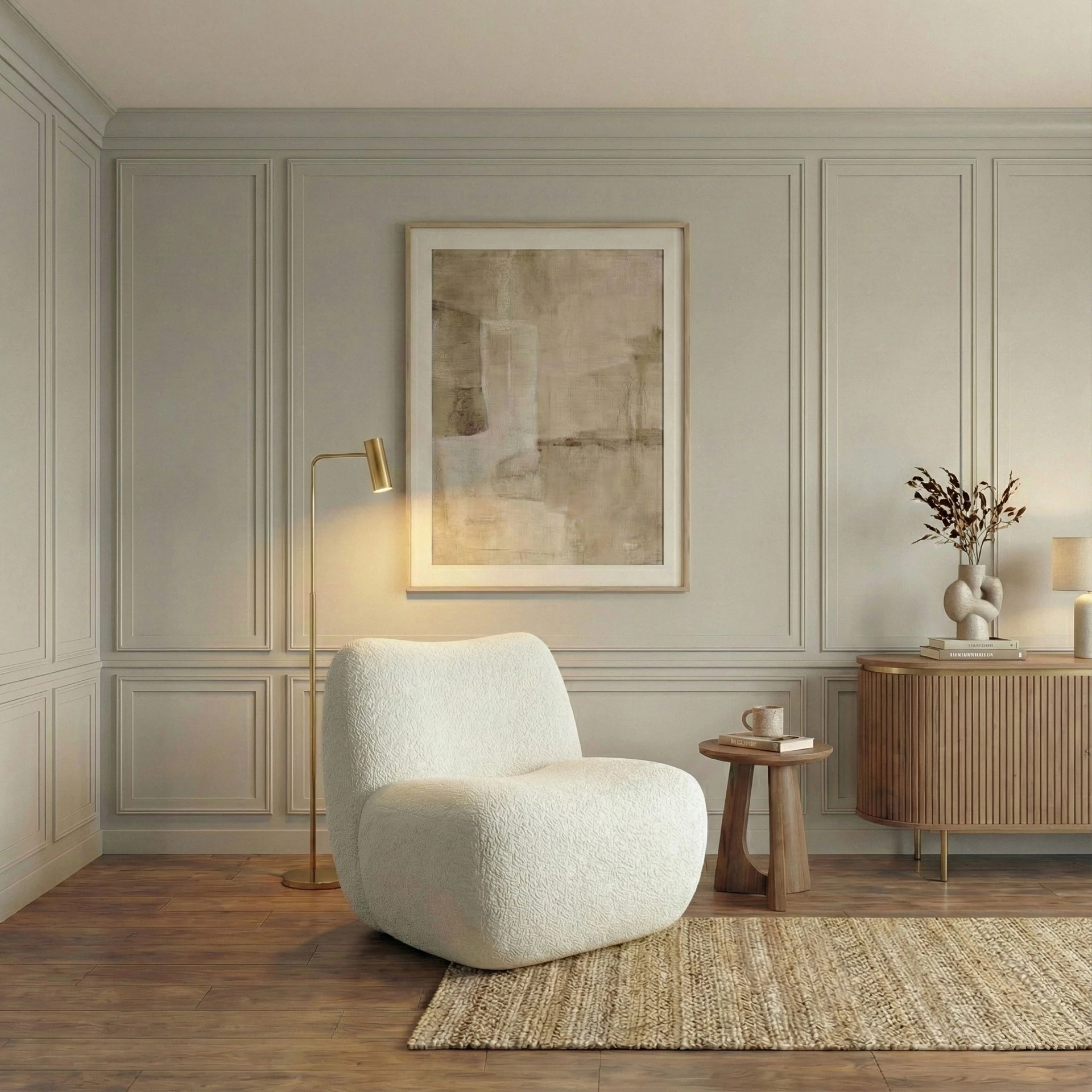 Bedroom detail with a bouclé armchair, a brass floor lamp, a round wooden side table and a fluted chest of drawers in front of the framed wall