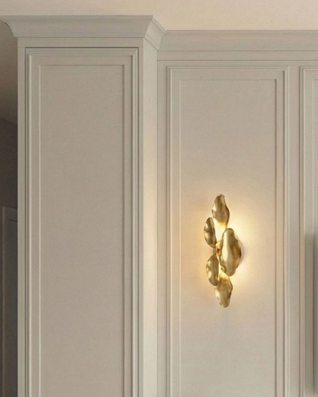 Moulded cornice and framed wall panels, with a brass wall light in one of the panels