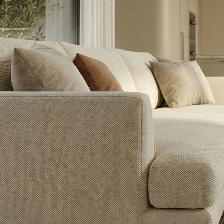 Close-up of the woven upholstery of the beige sofa, with beige and brown scatter cushions