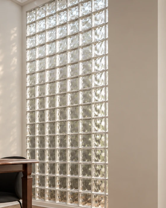 Glass block wall with a rippled surface beside the dining area