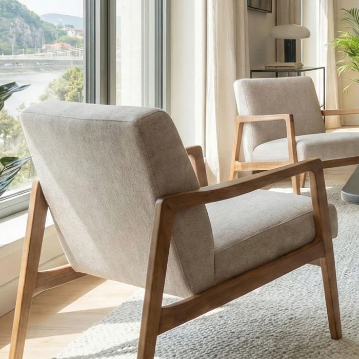 Close-up of an armchair with wooden armrests and light upholstery