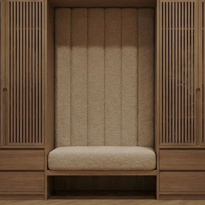 Built-in bench with a vertically stitched upholstered backrest between two slatted oak cabinet doors