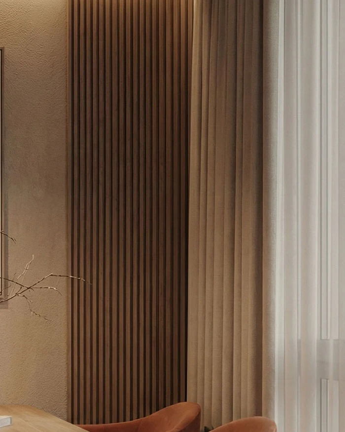 Vertical wood slats, a textured wall surface and a sheer curtain in the dining area